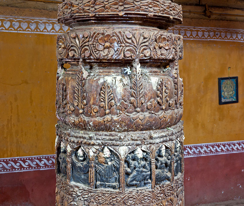Intricately carved wooden pillars inside the temple