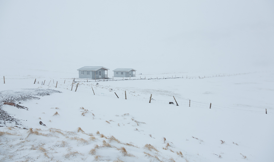 Urðartindur cottages in snow storm, Norðurfjörður