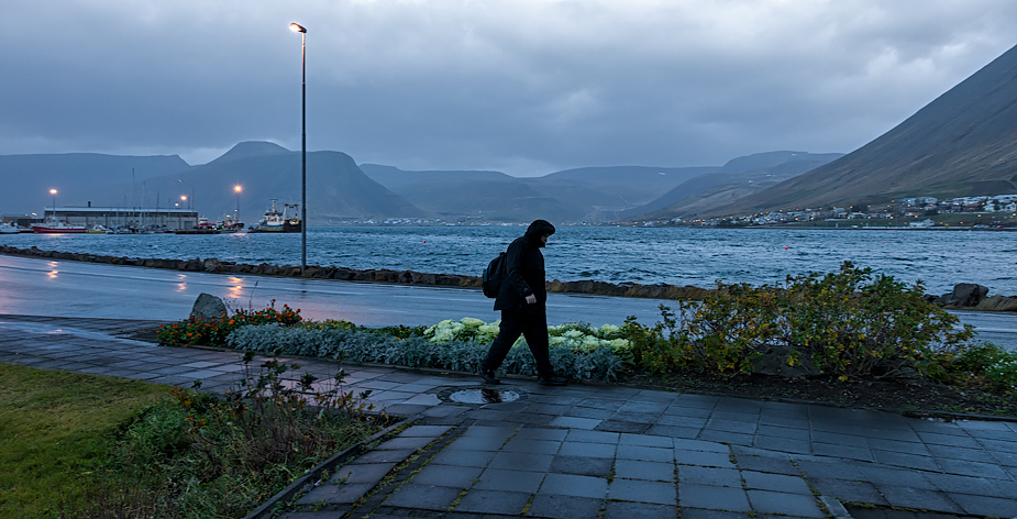 Lone walker on a stormy morning in Ísafjörður