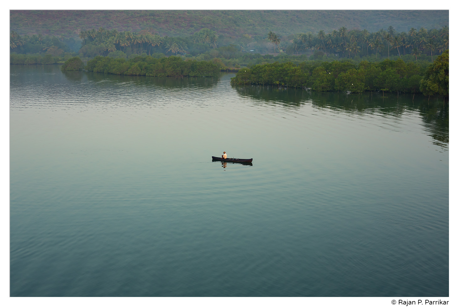 Lone fisherman on Chapora river in Siolim, Goa