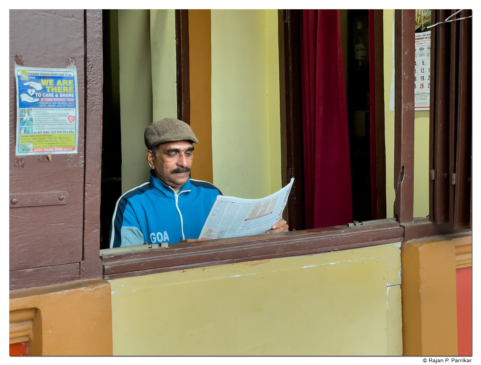 Reading newspaper in Divar, Goa